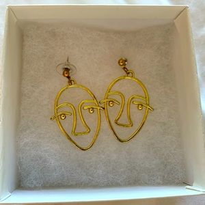 Gold face earrings